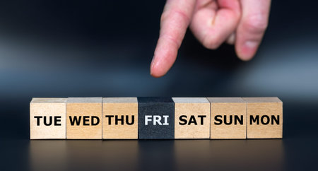Hand points to cube with letters 'FRI'.