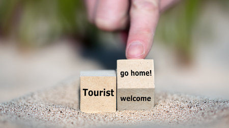 Wooden blocks with the words Tourist welcome and go home!の写真素材