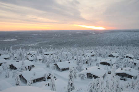 Wooden cabins in a snowy landscapeの写真素材