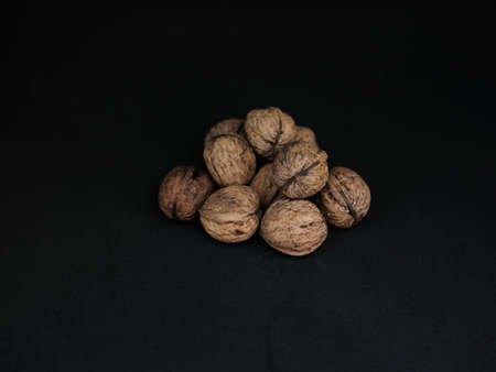 Close up of walnuts on a black backdropの写真素材