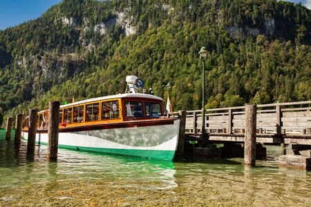 Electric tourist boats on beautiful lake Konigssee pier Berchtesgaden National Park Bavaria Germanyの写真素材