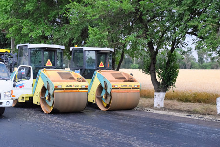 Stavropol, Russia - June 13, 2019: Construction of a new asphalt track. The rollers ram the asphalt....