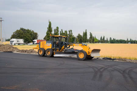 Stavropol, Russia - June 13, 2019: Construction of a new road. Heavy equipment on repair and construction of the track.のeditorial素材