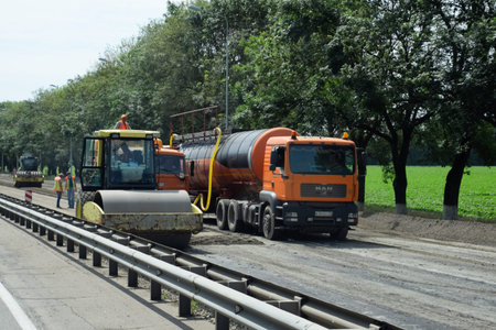 Stavropol, Russia - June 13, 2019: Construction of a new asphalt track. The rollers ram the asphalt....