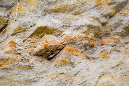 The sedimentary layers of the rock in the sand scree. sand, pebbles and shells in sedimentary rocks.