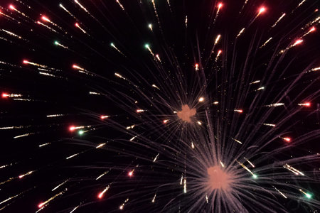 Festive salute in the night sky. Explosions of fireworks and pyrotechnics in the sky.