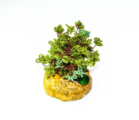 Creative wood made of copper wire and green beads.の写真素材