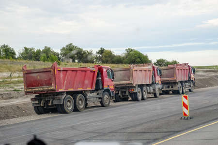 Taman, Russia - June 9, 2019: Tipper trucks are standing on the side of the road.のeditorial素材