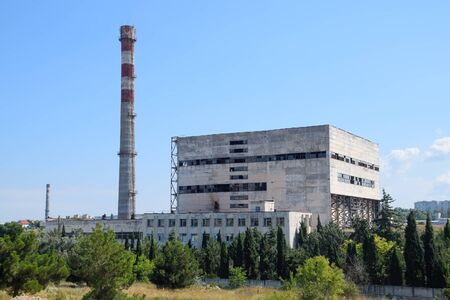 An old Soviet factory with a pipe. Abandoned Soviet industry.の写真素材
