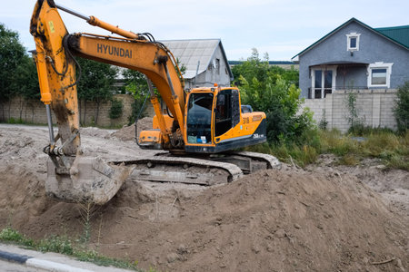 Taman, Russia - July 9, 2019: Excavator on the construction of the road. Heavy machinery for...