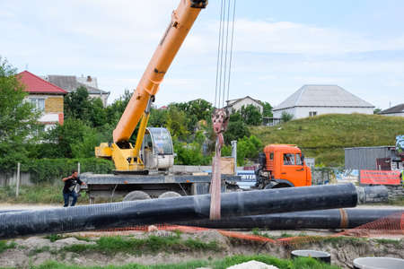 Taman, Russia - July 9, 2019: Excavator on the construction of the road. Heavy machinery for construction.のeditorial素材