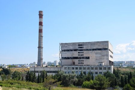 An old Soviet factory with a pipe. Abandoned Soviet industry.の素材 [FY310147634047]