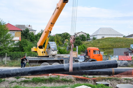 Taman, Russia - July 9, 2019: Excavator on the construction of the road. Heavy machinery for...