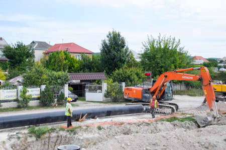 Taman, Russia - July 9, 2019: Excavator on the construction of the road. Heavy machinery for construction.のeditorial素材