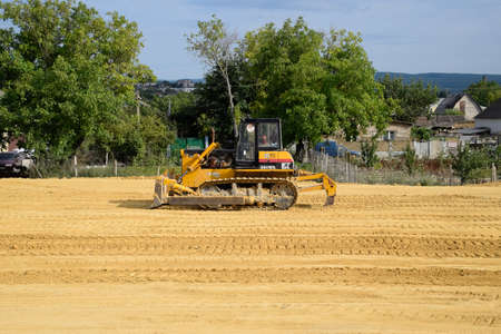 Taman, Russia - July 9, 2019: Excavator on the construction of the road. Heavy machinery for construction.のeditorial素材