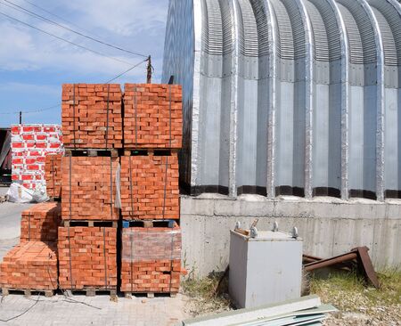 Warehouse of building materials. a Building base, metal, wood and blocks with bricks.の写真素材