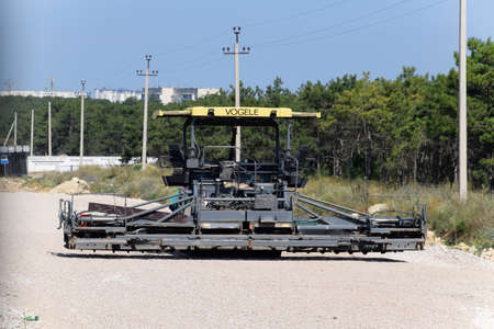 Taman, Russia - July 9, 2019: Techniques for the construction of the road. Asphalt dispenser.のeditorial素材