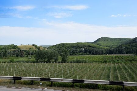 Landscapes of Crimean nature. Fields and hills visible from car window from the road.の写真素材