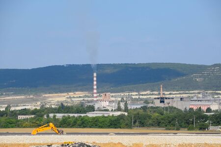 The chimney of the boiler room is smoking. boiler room away in the field.の写真素材