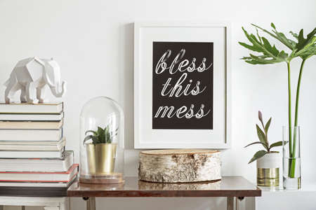 Interior of vintage space with mock up poster frame, plants, tropical leafs books and white elephant...