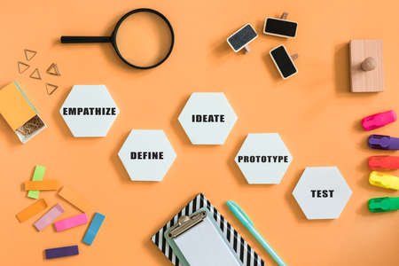 The top view of creative desk with design thinking process diagram, notebooks, succulents and pencils. Solutions for bussines, it, idea, start up, presentation.の写真素材