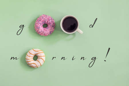 Sweet and colourful set of donuts with cup of coffee on the green background. Concept of good mornin...