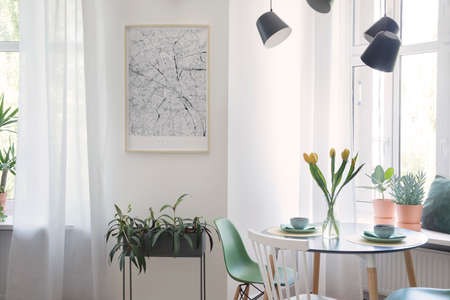 Stylish and modern open space with dining and living room with design map, sofa and family table....