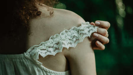 Discover the secret garden. Close up image of female hands touching the strap in the forest.の写真素材