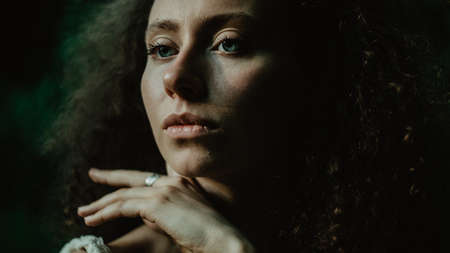 Portrait of female young beautiful dancer practicing with concentration on the dark background in...