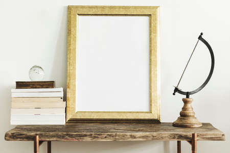 Stylish scandinavian composition of wooden console with gold mock up poster frame, beautiful plant...
