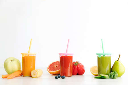 Composition of healthy detox juices and smoothies with seeds. Healthy vegetables and fruits on the white background, copy spaceの写真素材