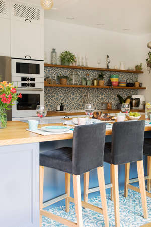 Fresh summer breakfast in Mediterranean style kitchen. Bright and sunny space with a lot of herbs...
