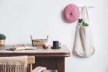 Vintage kitchen interior with mock up photo frame, cup of coffee, pink hat, white bag and box....