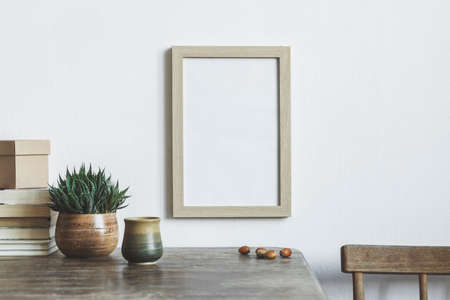 The room interior with mock up frame, succulent, books and cup of coffee. Minimalistic concept of retro table.の写真素材