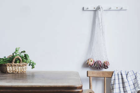 Vintage kitchen interior with copy space, straw basket, vegetables and bag with apples. Minimalist concept of kitchen space.の写真素材