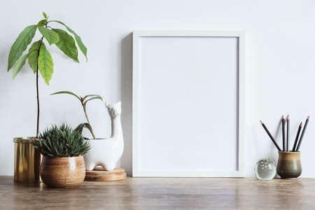 Interior of home space with mock up photo frame, avocado plant , white lama sculpture pot. and...
