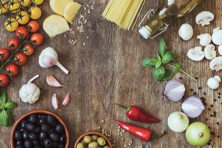 Modern composition of fresh food and ingredients on the vintage wooden table in the kitchen. Italian taste and look. Top view. Copy space.の写真素材