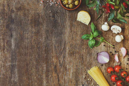 Modern composition of fresh food and ingredients on the vintage wooden table in the kitchen. Italian taste and look. Top view. Copy space.の写真素材