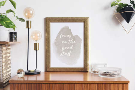 Retro and minimalistic interior with mock up photo frame on the vintage brown shelf, hanging plant...