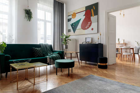 Luxury and modern home interior with design furniture, armchair, tables, pouf and accessroies. View...