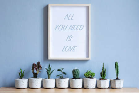 Minimalistic home interior with mock up photo frame on the brown wooden table with composition of...