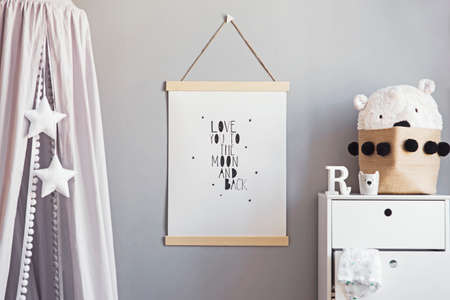 Stylish scandinavian nursery interior with hanging mock up poster, grey canopy with stars and white...