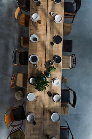 Stylish and modern interior design of conference room with design oak table, a lot of retro chairs,...
