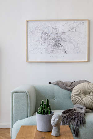 Stylish scandinavian living room interior with design mint sofa, furnitures, mock up poster map,...
