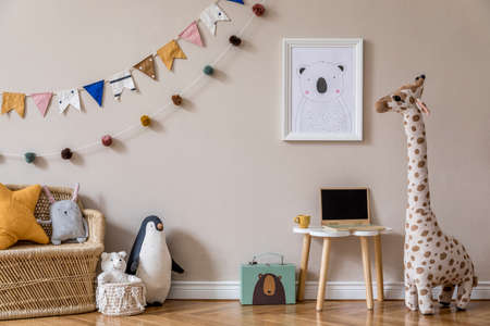 Stylish scandinavian kid room with mock up poster, toys, teddy bear, plush animal, natural pouf and children accessories. Modern interior with beige background walls. Template. Design home staging.の写真素材