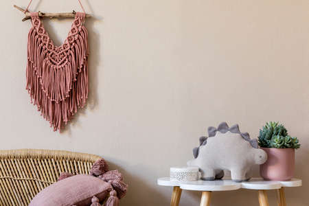 Stylish scandinavian nursery interior with plush dino, design furniture, toys, beautiful decoration and accessories in modern home decor for children room.の写真素材