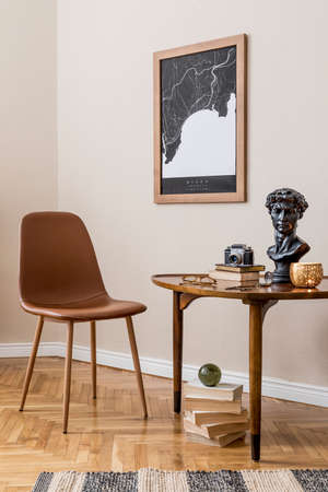 Stylish interior design of private library room with mock up poster map, brown chair, wooden table,...