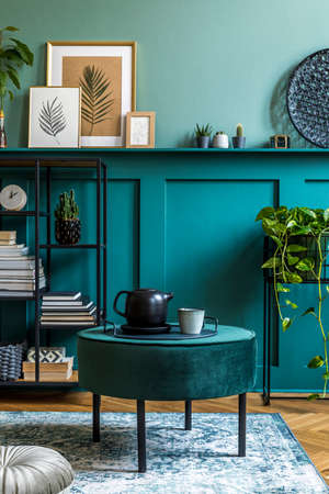 Interior design of living room with design pouf, shlef, basket, carpet and elegant personal...