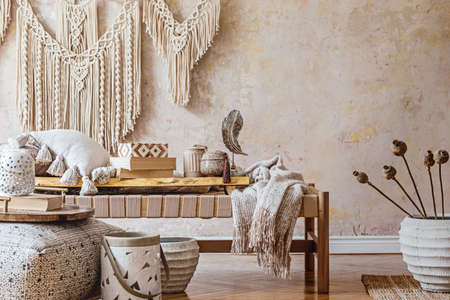 Modern oriental living room with design beige chaise longue, beautiful macrame, pillows, wooden tray, book, decoration and elegant personal accessories in home decor.の写真素材
