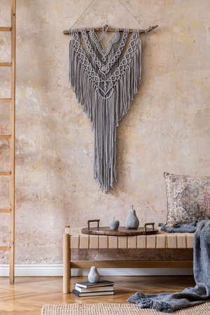 Interior design of stylish living room with beige chaise longue, pillows, lantern, macrame, dried flower, tea pot on the tray, decoration and elegant personal accessories in oriental concept.の写真素材